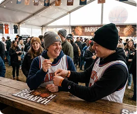 Fans exchanging a lucky Harvest Hoops coin at the counter